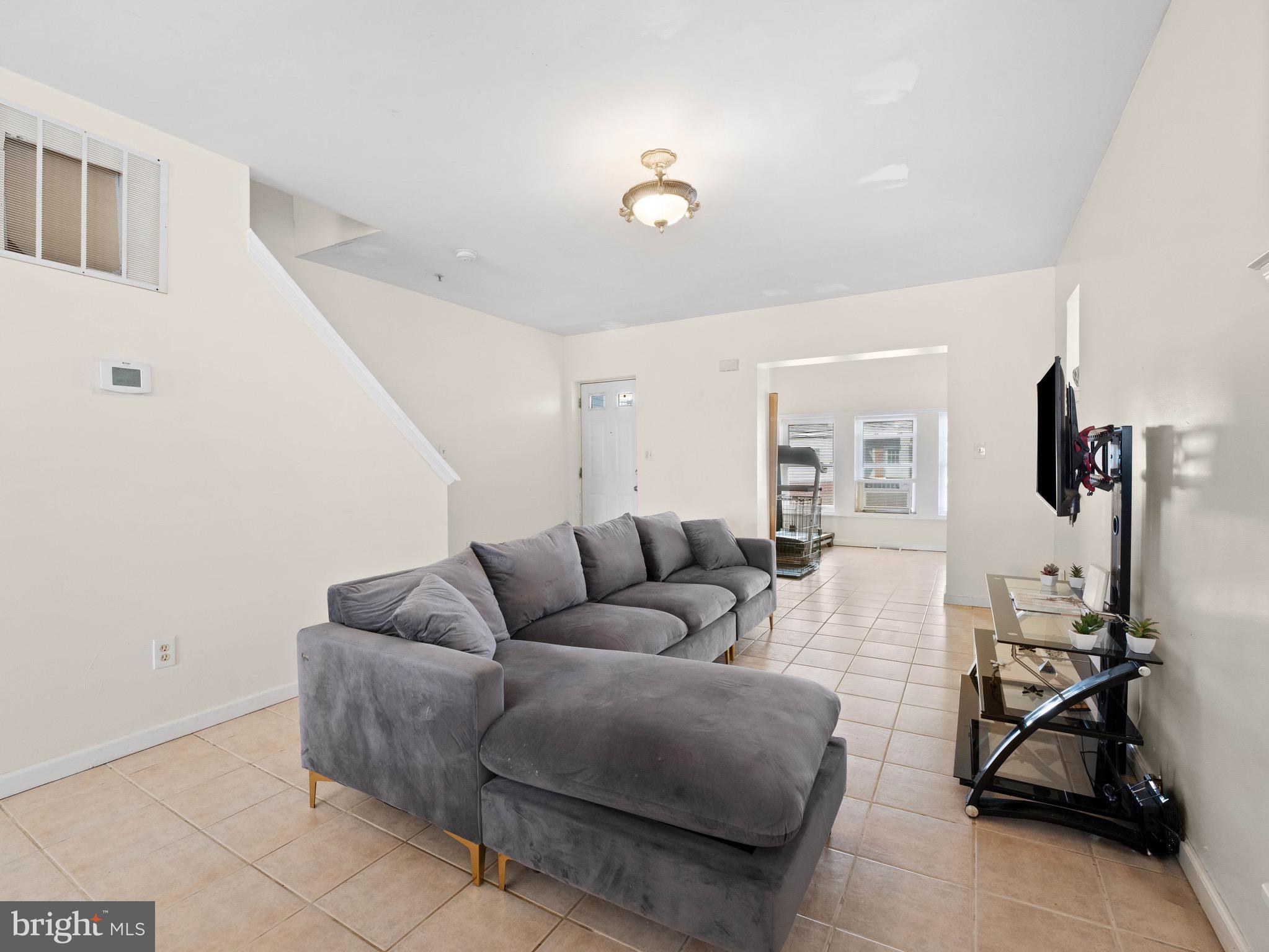 3014 Stevens Street Camden, NJ 08105 - Photo 4 of 34 a living room with furniture a window and gym equipment