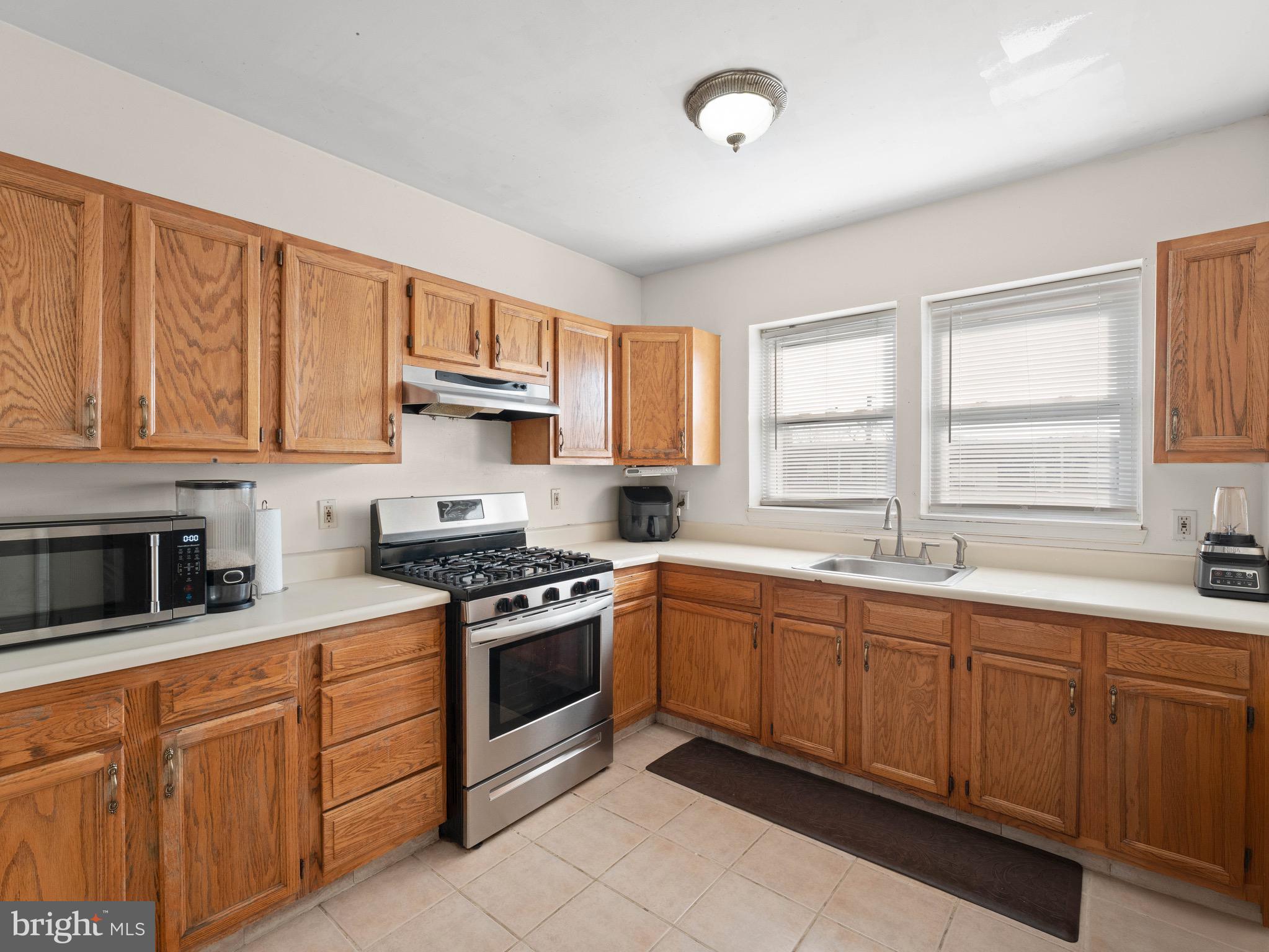 3014 Stevens Street Camden, NJ 08105 - Photo 9 of 34 a kitchen with stainless steel appliances granite countertop a stove sink and cabinets