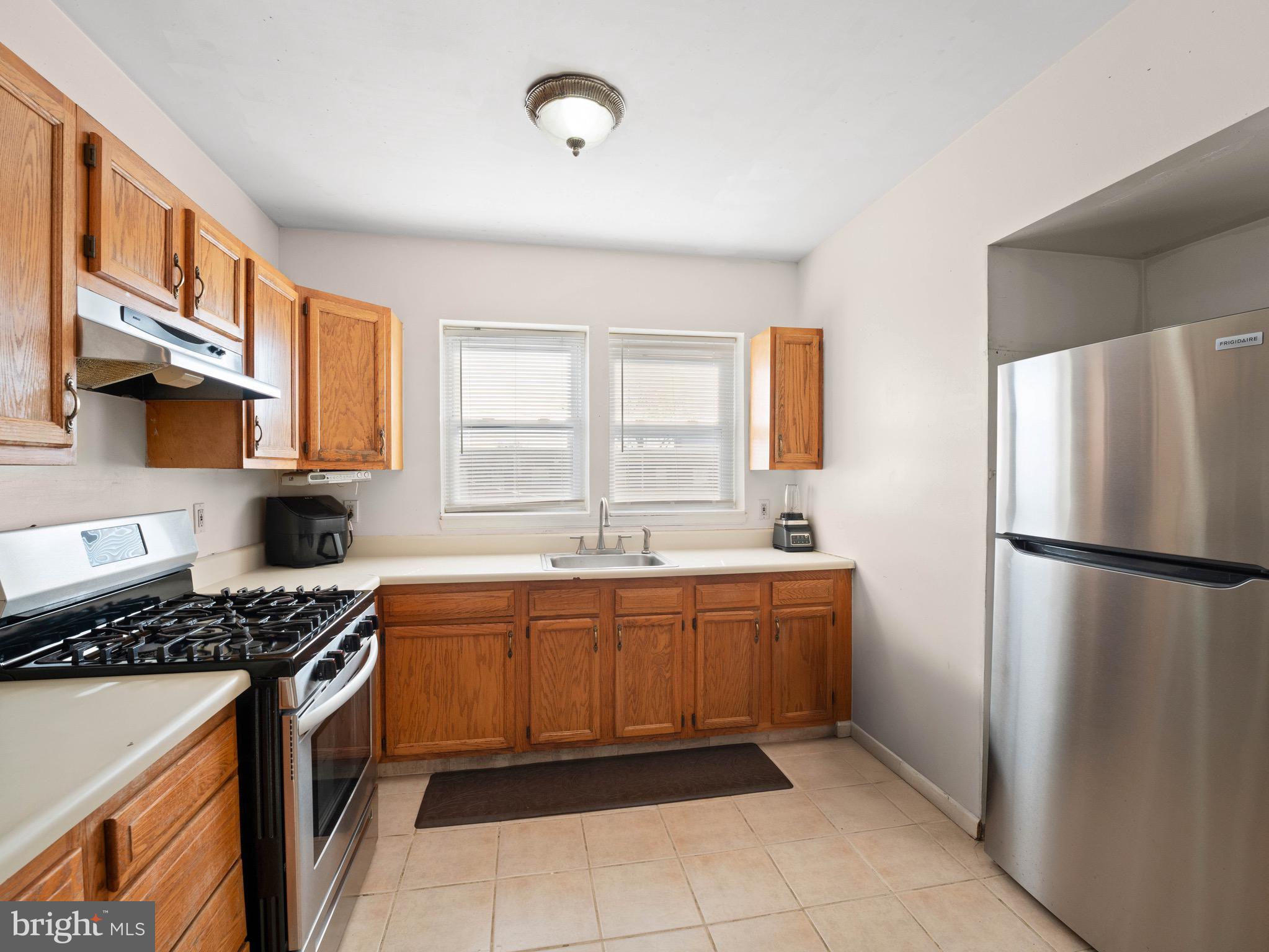 3014 Stevens Street Camden, NJ 08105 - Photo 10 of 34 a kitchen with stainless steel appliances a refrigerator sink and stove