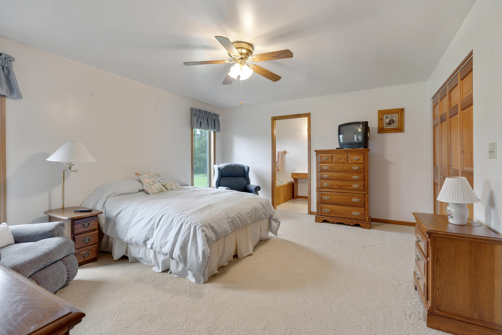 12402 Ridge Road Genoa, IL 60135 - Photo 13 of 31 a bedroom with bed and a chandelier