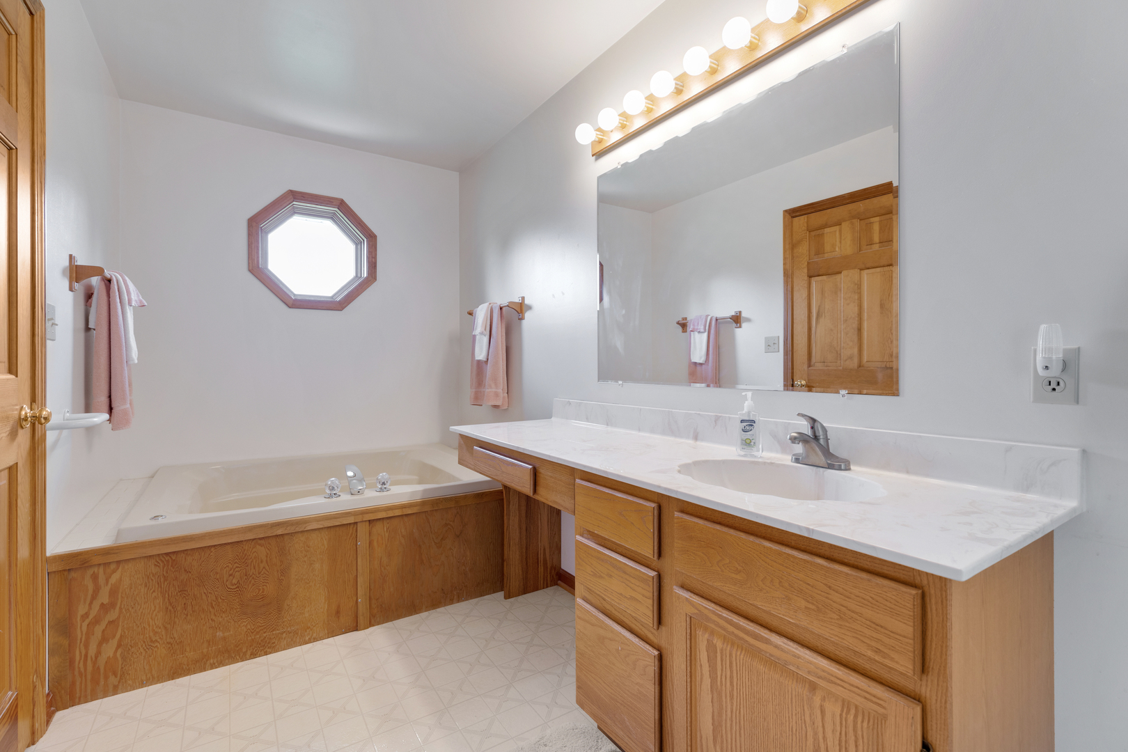 12402 Ridge Road Genoa, IL 60135 - Photo 14 of 31 a bathroom with a sink and a mirror