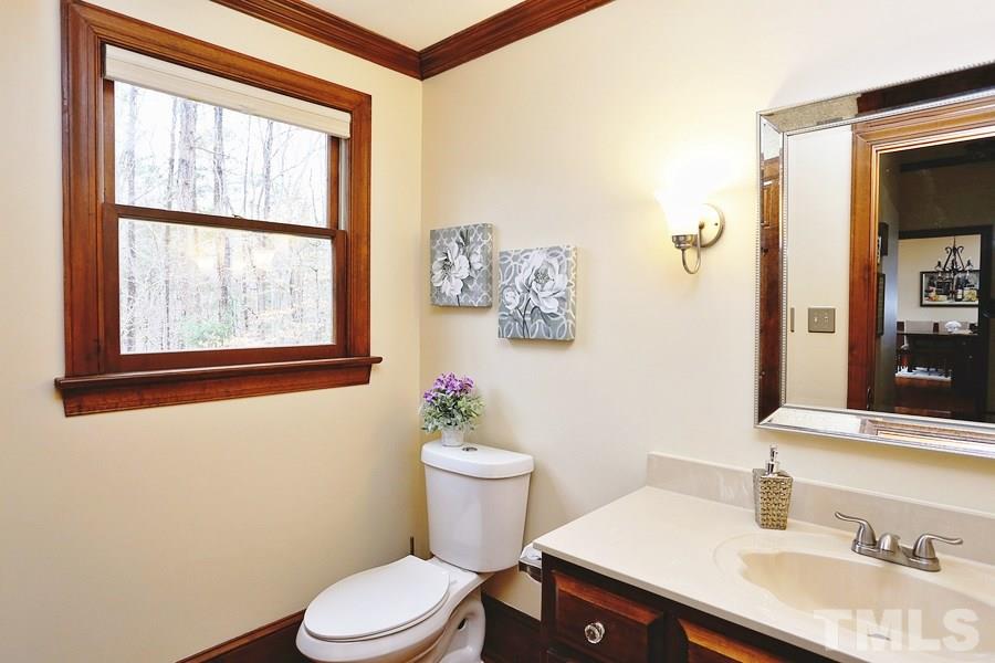 621 Hawick Road Raleigh, NC 27615 - Photo 14 of 25 a bathroom with a sink vanity mirror and toilet