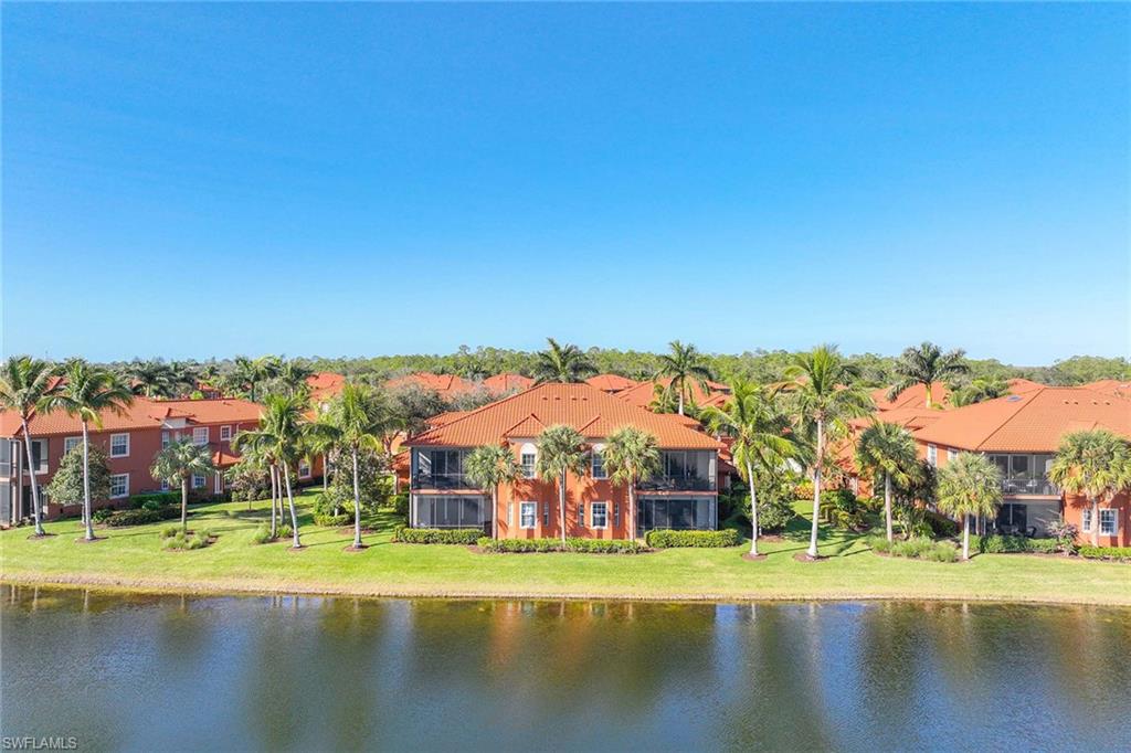 6438 Legacy Circle, Unit 301 Naples, FL 34113 - Photo 31 of 46 a view of pool with yard and lake view