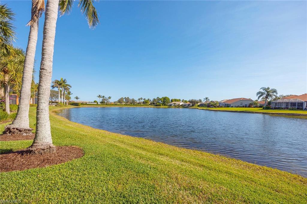 6438 Legacy Circle, Unit 301 Naples, FL 34113 - Photo 35 of 46 a view of a lake with a beach