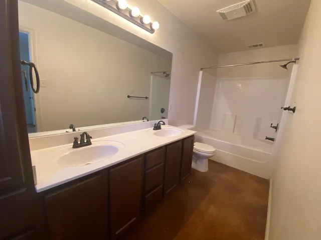 a bathroom with a double vanity sink and a mirror
