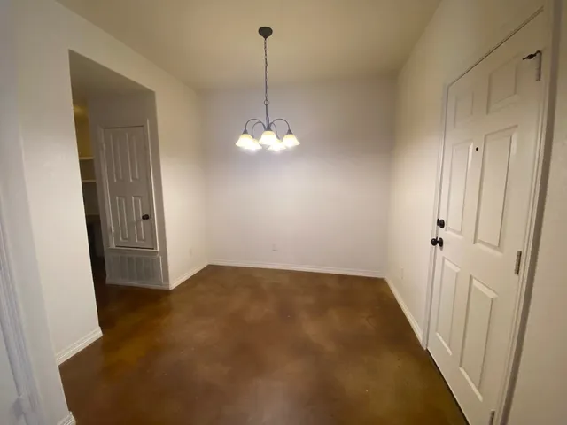 a view of a hallway with a chandelier