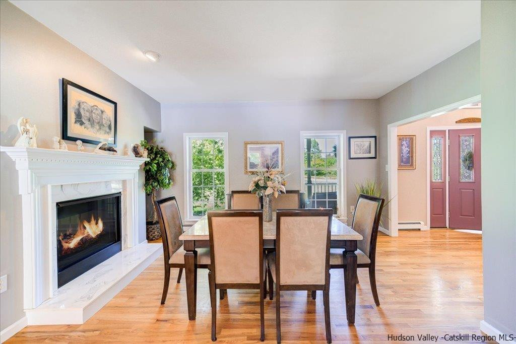 1237 Hoagerburgh Road Wallkill, NY 12589 - Photo 11 of 35 a dining room with furniture a fireplace and wooden floor