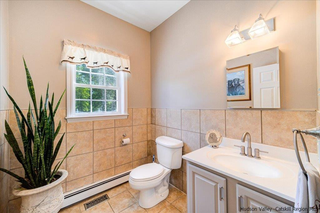 1237 Hoagerburgh Road Wallkill, NY 12589 - Photo 20 of 35 a bathroom with a toilet sink and mirror
