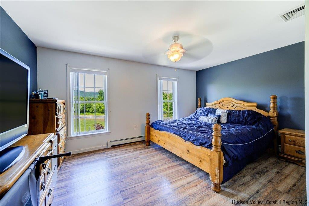 1237 Hoagerburgh Road Wallkill, NY 12589 - Photo 23 of 35 a bedroom with a bed and a flat tv screen on the dresser