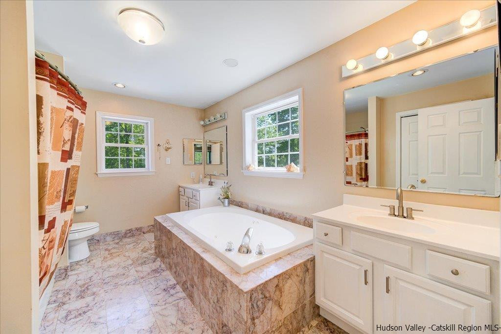 1237 Hoagerburgh Road Wallkill, NY 12589 - Photo 27 of 35 a bathroom with a tub sink and mirror