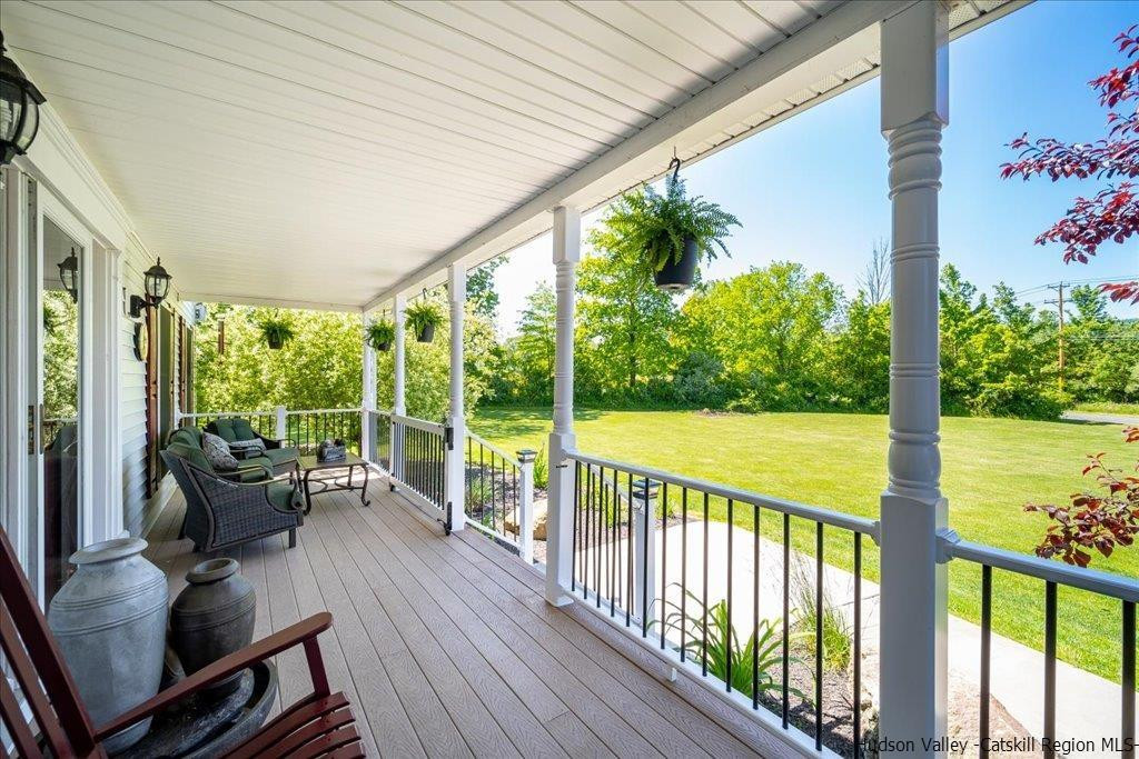 1237 Hoagerburgh Road Wallkill, NY 12589 - Photo 3 of 35 a view of a balcony with chairs and wooden floor