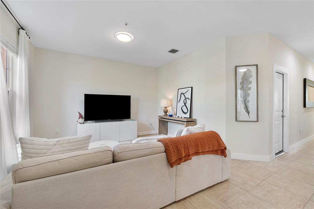 163 Southwest 7th Street Pompano Beach, FL 33060 - Photo 17 of 54 a living room with furniture and a flat screen tv