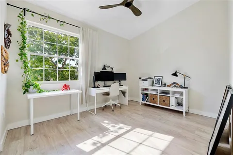 a bedroom with a potted plant and a window