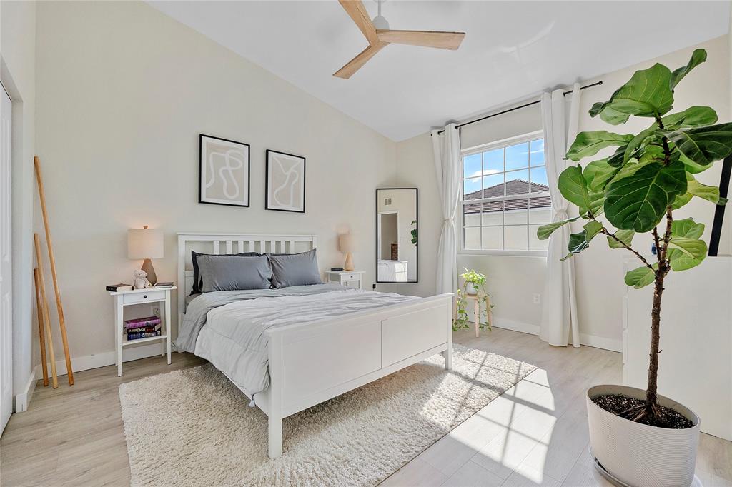 163 Southwest 7th Street Pompano Beach, FL 33060 - Photo 22 of 54 a bedroom with a potted plant and a window