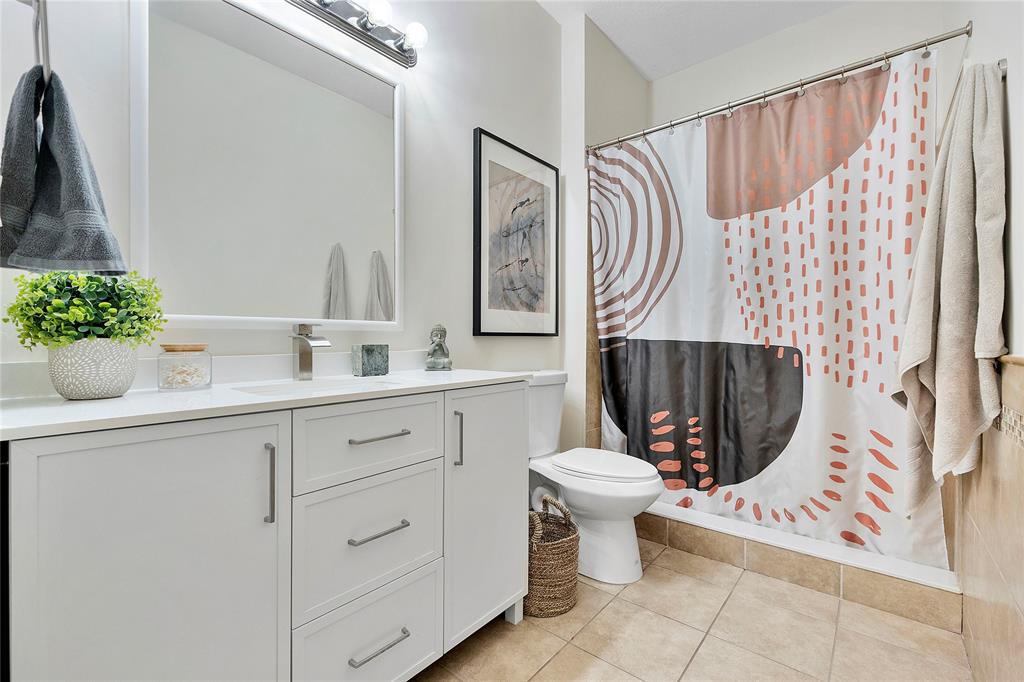 163 Southwest 7th Street Pompano Beach, FL 33060 - Photo 24 of 54 a bathroom with a toilet sink and mirror