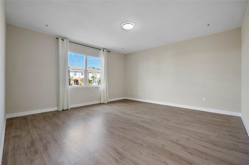 163 Southwest 7th Street Pompano Beach, FL 33060 - Photo 26 of 54 wooden floor in an empty room with a window