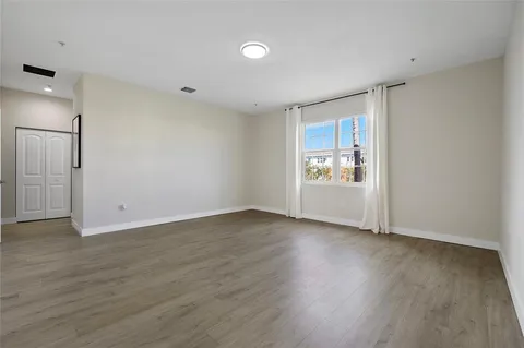 a spacious bathroom with double sink a large mirror and a bathtub