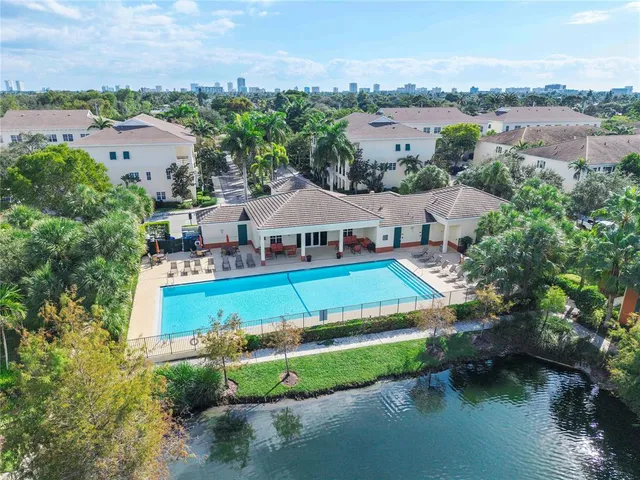 a view of a house with pool and a yard