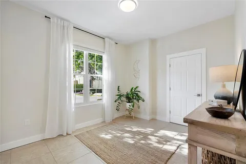 a view of a bedroom with workspace and a window