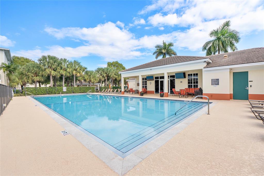 163 Southwest 7th Street Pompano Beach, FL 33060 - Photo 42 of 54 a view of a house with pool and a yard