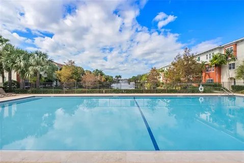 an aerial view of residential houses with outdoor space and lake view