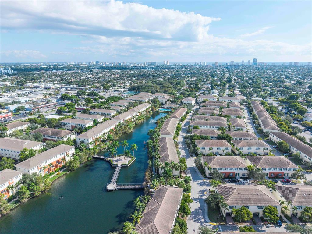 163 Southwest 7th Street Pompano Beach, FL 33060 - Photo 50 of 54 an aerial view of a city with lots of residential buildings ocean and mountain view in back