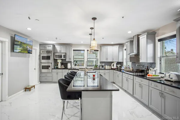 a kitchen with counter top appliances and windows