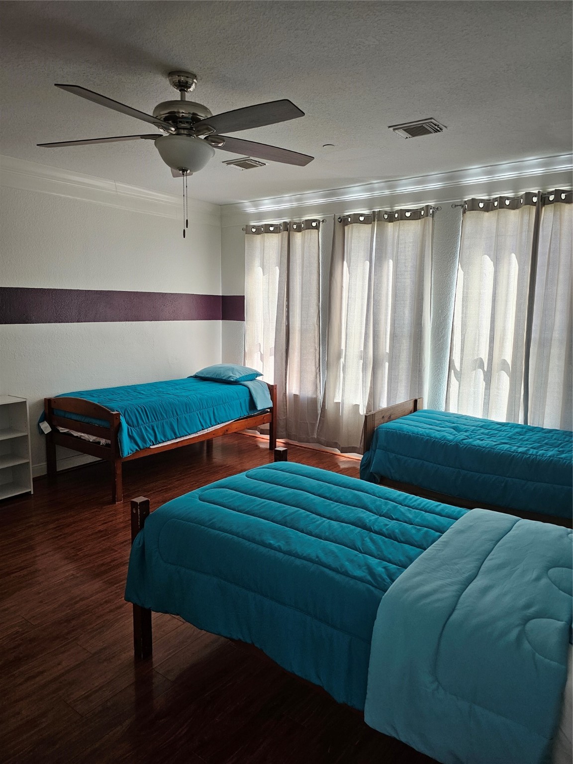 1211 Lark Lane Richmond, TX 77469 - Photo 11 of 24 a bedroom with a bed and a chandelier