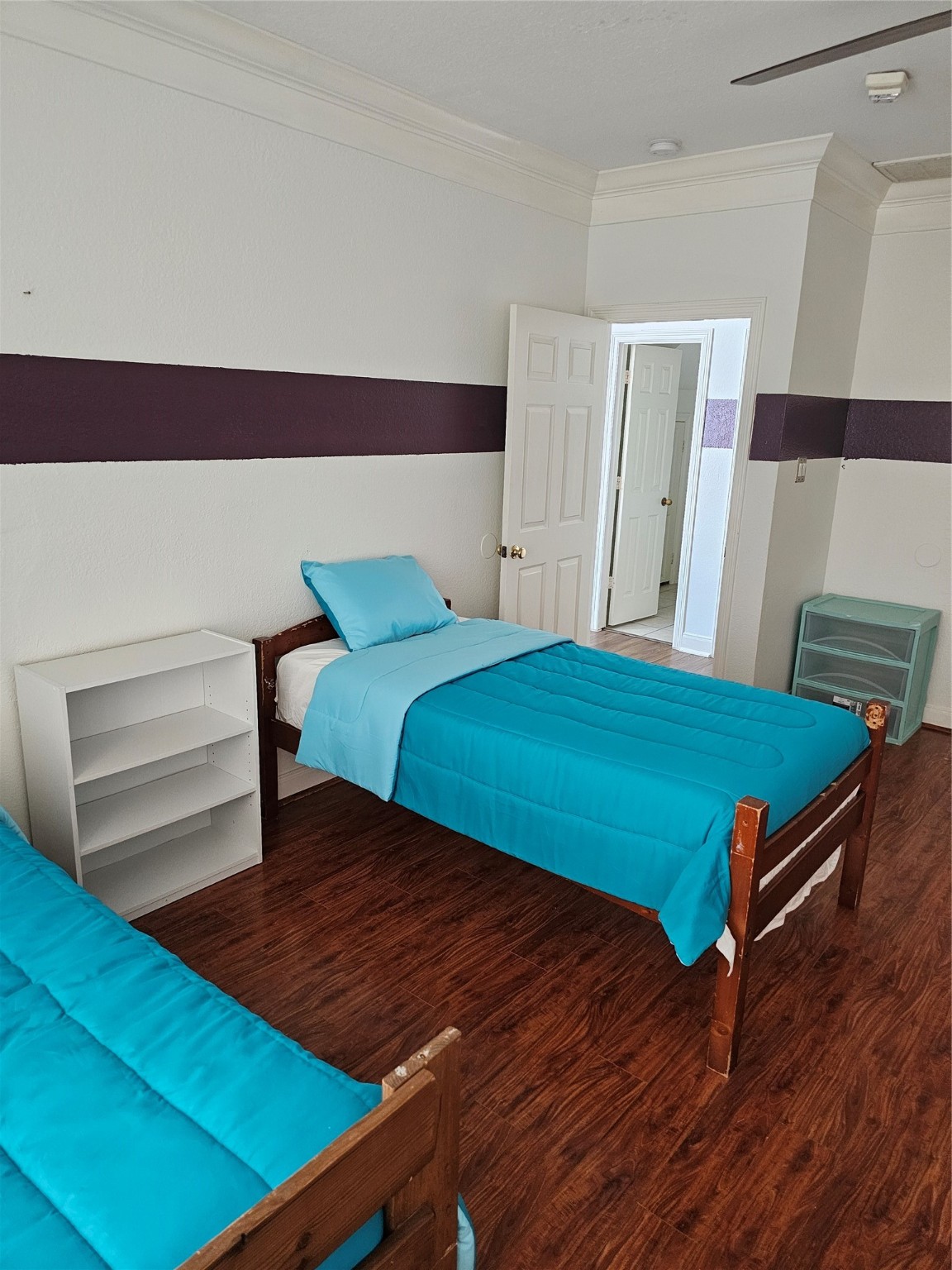 1211 Lark Lane Richmond, TX 77469 - Photo 12 of 24 a bedroom with a bed and wooden floor