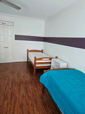 a bedroom with a bed and a dresser