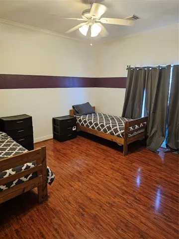 a living room with furniture rug and wooden floor