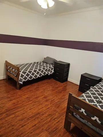 a bedroom with wooden floor