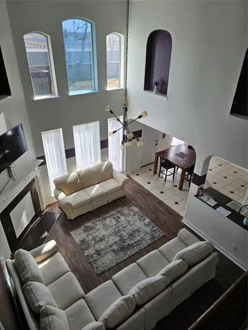 a living room with furniture and a mirror