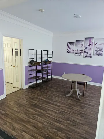 a view of a room with furniture and wooden floor