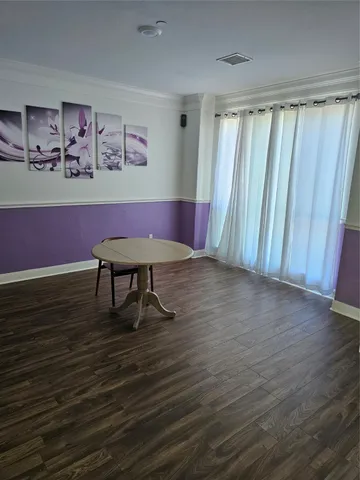 a view of a room with wooden floor
