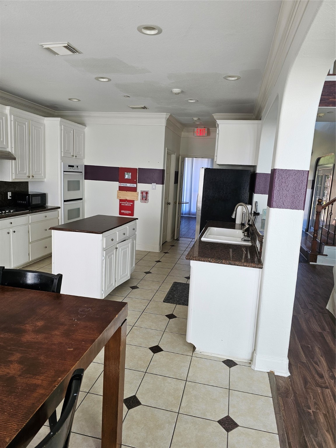 1211 Lark Lane Richmond, TX 77469 - Photo 7 of 24 a kitchen with stainless steel appliances a stove a sink a microwave a refrigerator and cabinets
