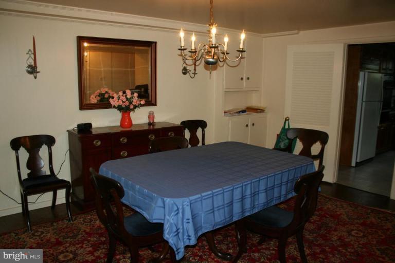 5903 Greentree Road Bethesda, MD 20817 - Photo 11 of 19 a dining room with furniture and chandelier