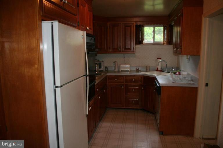 5903 Greentree Road Bethesda, MD 20817 - Photo 12 of 19 a kitchen with a refrigerator and a sink