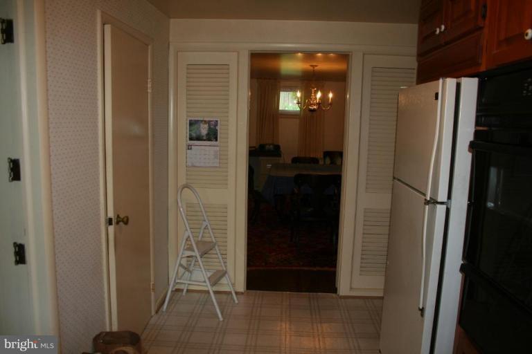 5903 Greentree Road Bethesda, MD 20817 - Photo 14 of 19 a bathroom with a glass shower door and a sink