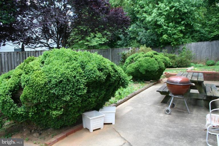 5903 Greentree Road Bethesda, MD 20817 - Photo 16 of 19 a view of a chair and table in backyard of wooden fence