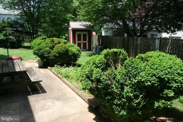 5903 Greentree Road Bethesda, MD 20817 - Photo 17 of 19 a view of a backyard with plants and lake view