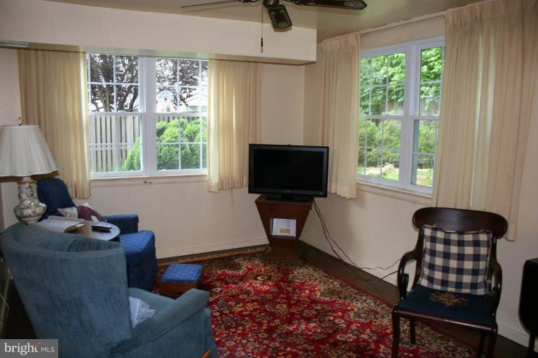 5903 Greentree Road Bethesda, MD 20817 - Photo 10 of 19 a living room with furniture a window and a flat screen tv