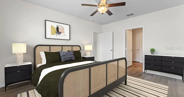 a bedroom with a bed and painting on the wall