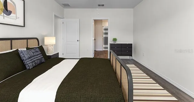 a bedroom with a bed and a window