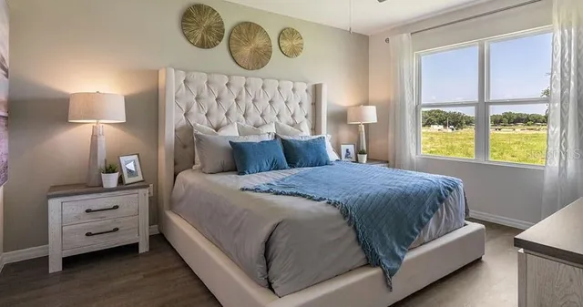 a bedroom with a bed and a window