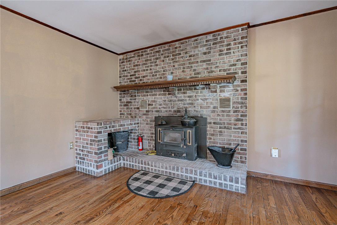 652 Old State Road Oley, PA 19547 - Photo 23 of 54 A classic brick fireplace with a wood-burning stove anchors this inviting room.