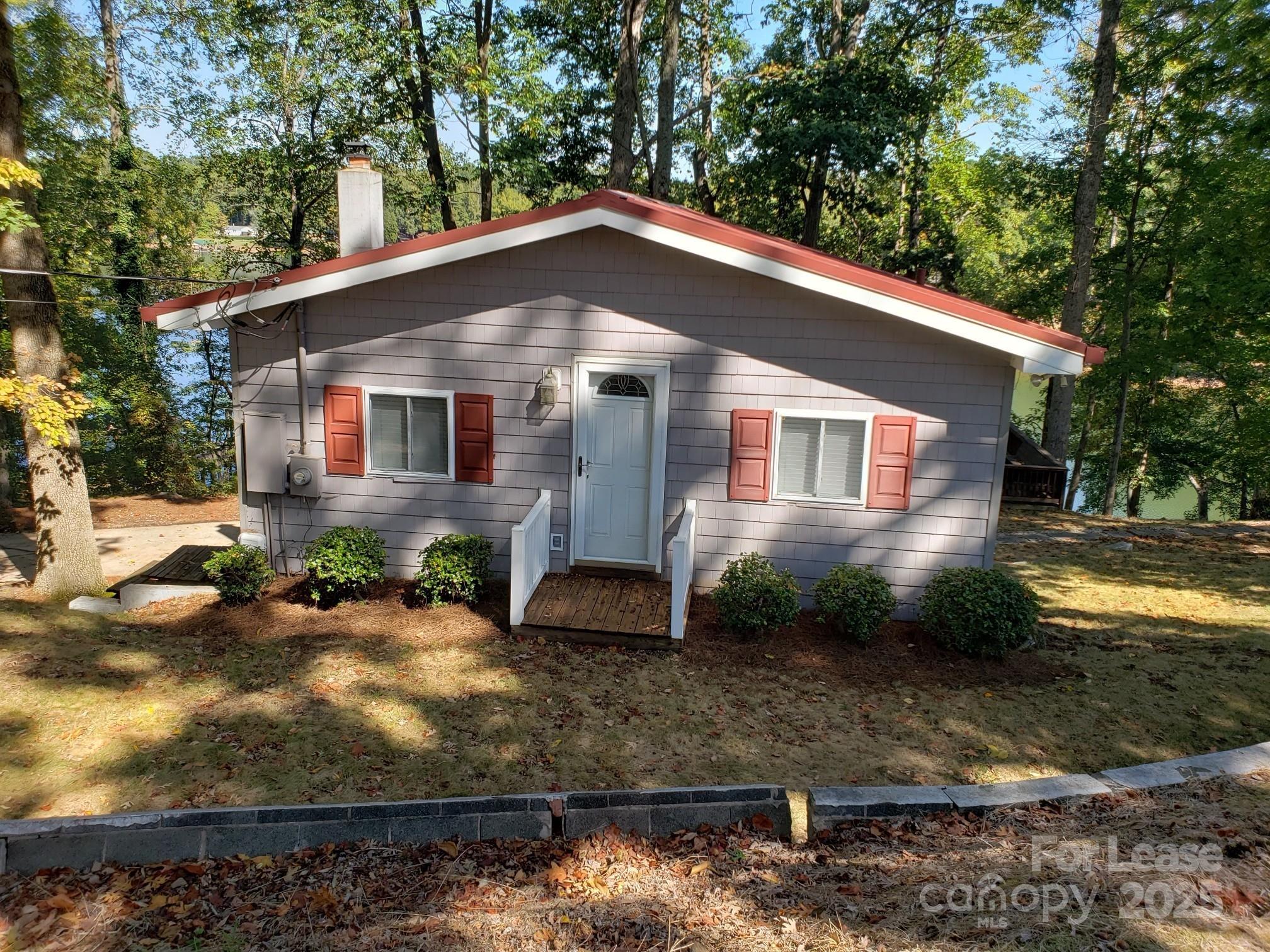 232 Hermance Lane Mooresville, NC 28117 - Photo 6 of 21 a view of a yard in front of a house with large windows