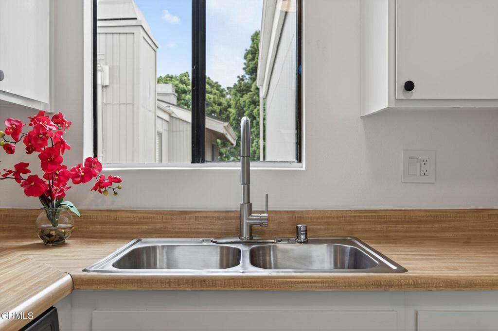 1466 San Simeon Court, Unit 2 Ventura, CA 93003 - Photo 10 of 41 a kitchen with a sink and a potted plant