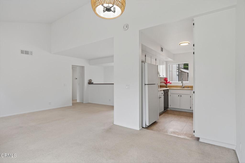 1466 San Simeon Court, Unit 2 Ventura, CA 93003 - Photo 13 of 41 a view of a kitchen with refrigerator and white cabinets