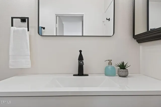 a bathroom with a sink a vanity and a mirror